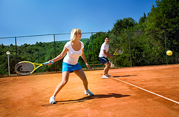 Coppia che gioca a tennis in un campo da tennis