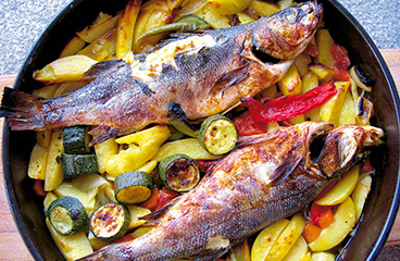 Vis met aardappelen bereid onder een bakdeksel