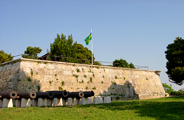 a stone wall with a flag on it and a flag on top