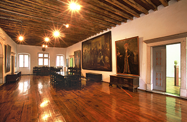 a large room with a large painting on the wall