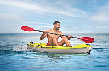 a person paddle boarding in the water