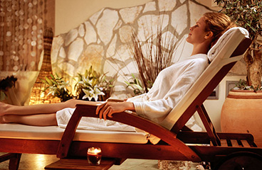 Woman relaxing on a sun lounger in the relaxation spa area