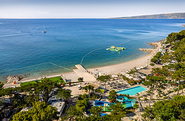a beach with many people and boats