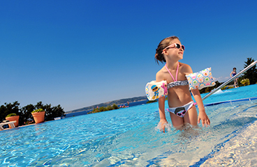 Meisje met duikbril staat in het verwarmde zoetwater kinderzwembad