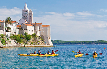 a group of people in kayaks in a body of water