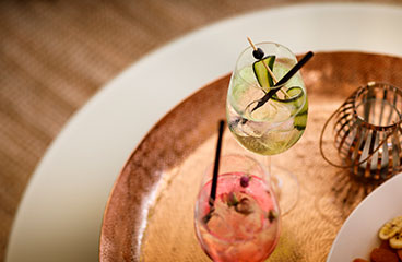 a table with a glass of water and a book on it