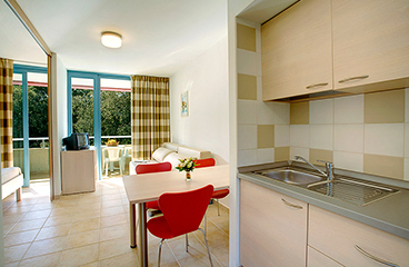 a kitchen with a table and chairs